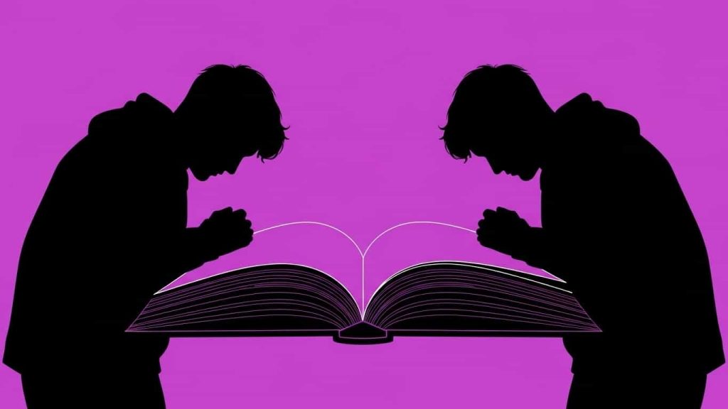 Silhouette of mirrored figures on a book to represent doppelgängers in literature.